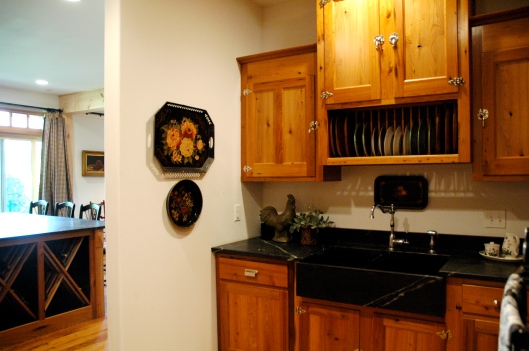 They chose to tuck the main sink, microwave, and an additional wall oven around a corner to hide the more utilitarian items/ less pretty things... like dirty dishes and the Keurig. 